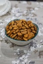 Toasted almonds on a bowl on a table with floral black and white decoration Royalty Free Stock Photo