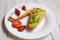 Toasted baguette with avocado, tomato and cheese. on a light wooden background Royalty Free Stock Photo