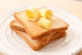 Toasted bread with butter curls on plate Royalty Free Stock Photo