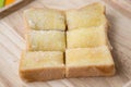 Toasted bread with butter and sugar in wooden tray with table background Royalty Free Stock Photo