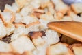 Toasted bread cubes with spatula close up