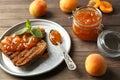 Toasted bread with delicious apricot jam on plate Royalty Free Stock Photo