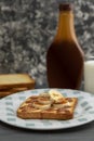 toasted bread in the foreground with banana and cajeta