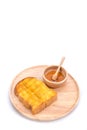 Toasted bread with honey and honey dipper on white background