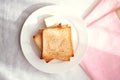 Toasted bread slices with butter pat for breakfast Royalty Free Stock Photo