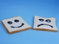 toasted bread with smiley and sad emoticons, for the concept of happiness and sadness