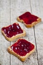 Toasted cereal bread slices with homemade cherry jam closeup on rustic wooden table background Royalty Free Stock Photo
