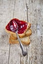 Toasted cereal bread slices stack with homemade cherry jam and spoon closeup on rustic wooden table background Royalty Free Stock Photo