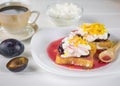 Breakfast of French bread with curd cream, plum jam and orange zest on a white table. Royalty Free Stock Photo