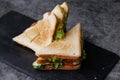 Toasted Sandwich With Lettuce, Tomato, Cheese and Ham, Triangular Slices on Slate Surface Royalty Free Stock Photo