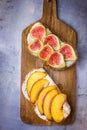 Toasted sandwiches with cream cheese topped with fresh ripe figs and peaches. Drizzled with honey. Wholegrain rye bran bread