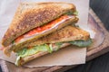 Toasted sandwiches with tomato and ham in rustic wooden plate Royalty Free Stock Photo