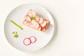 Toasted toast with fresh chopped radishes and green herb on the white plate. Healthy breakfast. Sandwich with vegetable. Royalty Free Stock Photo