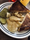 Toasted tuna melt with potato chips, and pickles