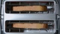 Toaster toasts bread toast to a burnt level, top view, accelerated time-lapse