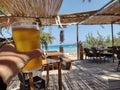 Toasting a beer in a beach bar on a tropical island