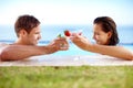 Toasting to our love. Young couple making a toast with cocktails in the pool. Royalty Free Stock Photo