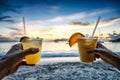 Toasting with tropical drinks on the beach.
