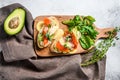 Toasts with avocado and smoked salmon. White background. Top view Royalty Free Stock Photo