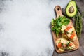 Toasts with avocado and smoked salmon. White background. Top view. Copy space Royalty Free Stock Photo