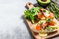 Toasts with avocado and smoked salmon. White background. Top view. Copy space Royalty Free Stock Photo