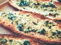 Toasts with basil and garlic close-up on a plate. Royalty Free Stock Photo