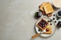 Toasts, blueberry jam and cup of coffee served on light marble table, flat lay. Space for text Royalty Free Stock Photo