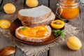 Toasts of bread with apricot jam and fresh fruits with mint on an old wooden table. Tasty breakfast Royalty Free Stock Photo