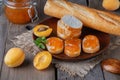 Toasts of bread with apricot jam and fresh fruits with mint on an wooden table. Royalty Free Stock Photo