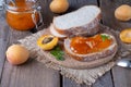 Toasts of bread with apricot jam and fresh fruits with mint on an old wooden table. Tasty breakfast Royalty Free Stock Photo