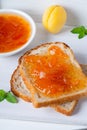 Toasts of bread with apricot jam and fresh fruits with mint. Royalty Free Stock Photo