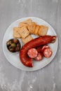 toasts with chourico and olives on dish Royalty Free Stock Photo