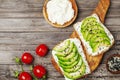 Toasts with creamy cheese and avocado for healthy snack or breakfast. Top view