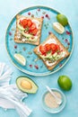 Toasts with feta cheese, tomatoes, avocado, pomegranate, pumpkin seeds and flaxseed sprouts. Diet breakfast. Delicious and healthy Royalty Free Stock Photo