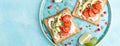 Toasts with feta cheese, tomatoes, avocado, pomegranate, pumpkin seeds and flaxseed sprouts. Diet breakfast. Delicious and healthy Royalty Free Stock Photo