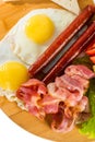 Toasts, fried eggs, sausages, meat and vegetables