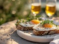 Toasts with fried eggs and two glasses of bear, served outdoors. Traditional food for midsummer celebrations. Generative AI Royalty Free Stock Photo