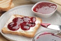 toasts with jam. fried crispy toast with red jam on a natural wooden table. breakfast