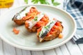 Toasts of marinated anchovies with fresh tomato and olive oil Royalty Free Stock Photo