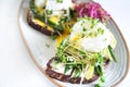 Toasts with microgreens, avocado, asparagus and poached egg Royalty Free Stock Photo