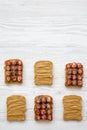 Toasts with peanut butter, strawberries and chia seeds over white wooden background, top view. Healthy eating. Royalty Free Stock Photo