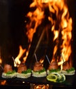 Toasts with salmon on burning flame background. Healthy breakfast with wholemeal bread toasts with redfish on slate