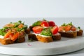 Toasts with salmon, cherry, microgreens, open sandwich with fish on white marple board white background, healthy snack Royalty Free Stock Photo