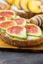 Toasts sandwiches with wholemeal rye bran bread, cream cheese or yoghurt, ripe figs and peaches. Wood honey dipper