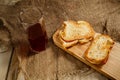 Toasts with sausage and cheese on a wooden stand and a glass of natural juice. The concept of tasty and natural food. Royalty Free Stock Photo