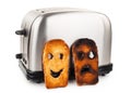 Toasts with smiley face in toaster Royalty Free Stock Photo