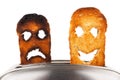 Toasts with smiley face in toaster Royalty Free Stock Photo