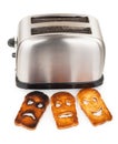 Toasts with smiley face in toaster Royalty Free Stock Photo