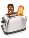 Toasts with smiley face in toaster Royalty Free Stock Photo