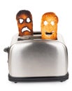 Toasts with smiley face in toaster Royalty Free Stock Photo